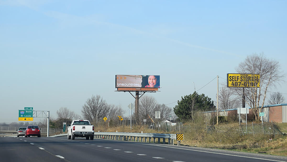 Billboard featuring Unbound.org beside a self-storage sign.