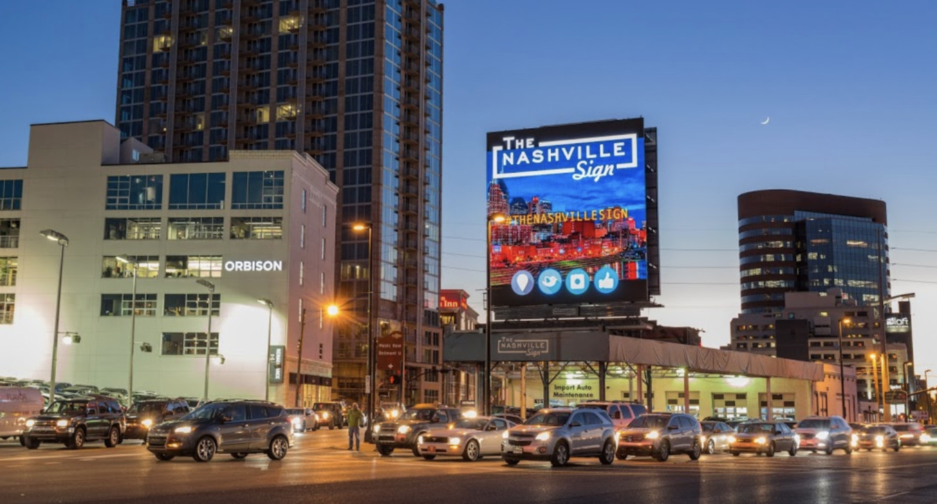 Digital billboards displayed along a busy street in Nashville
