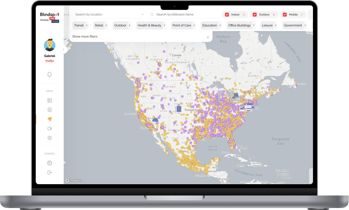 MacBook Pro mockup displaying a digital out-of-home advertising dashboard