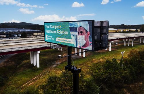 Digital out-of-home billboard displayed along a highway in Arkansas