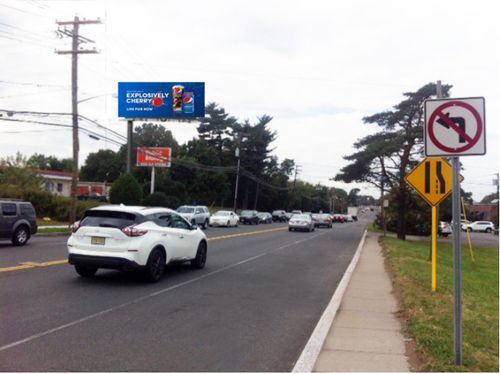 Digital out-of-home billboard displayed along a roadway in New Jersey